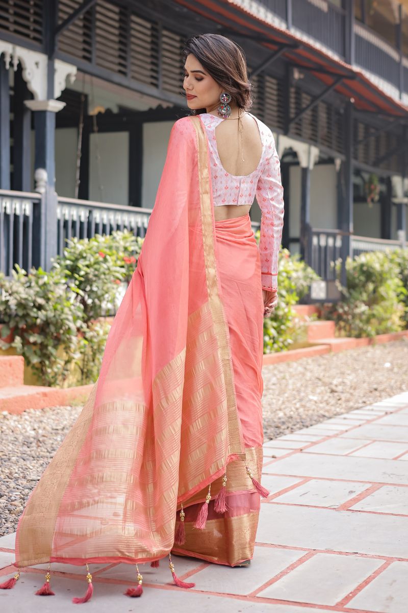 This peach-pink, silky, lightweight chiffon saree flows beautifully.