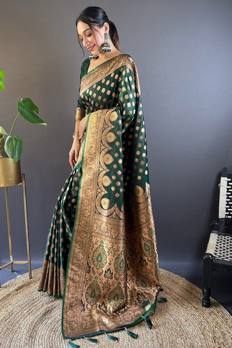 Tiny zari weaving adorn these dark green Banarasi Katan Silk Sarees.