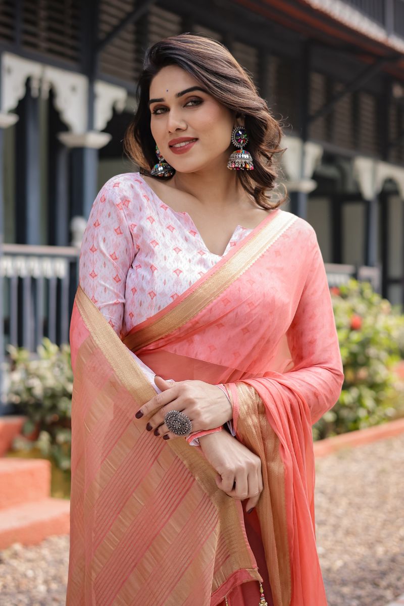 This peach-pink, silky, lightweight chiffon saree flows beautifully.
