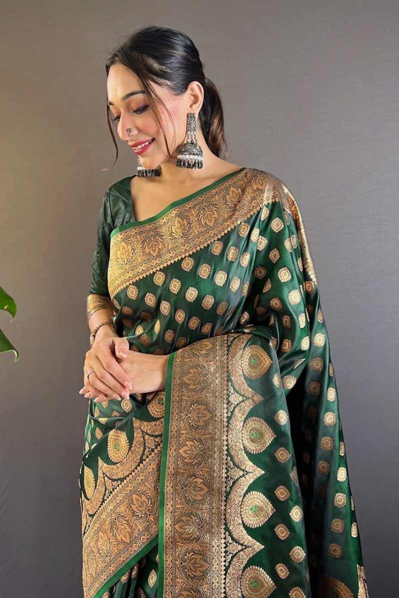 Tiny zari weaving adorn these dark green Banarasi Katan Silk Sarees.