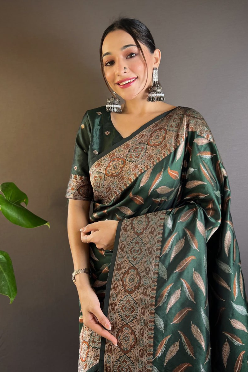 Sarees made of soft silk in a dark green color with distinctive triple Zari paan weaves