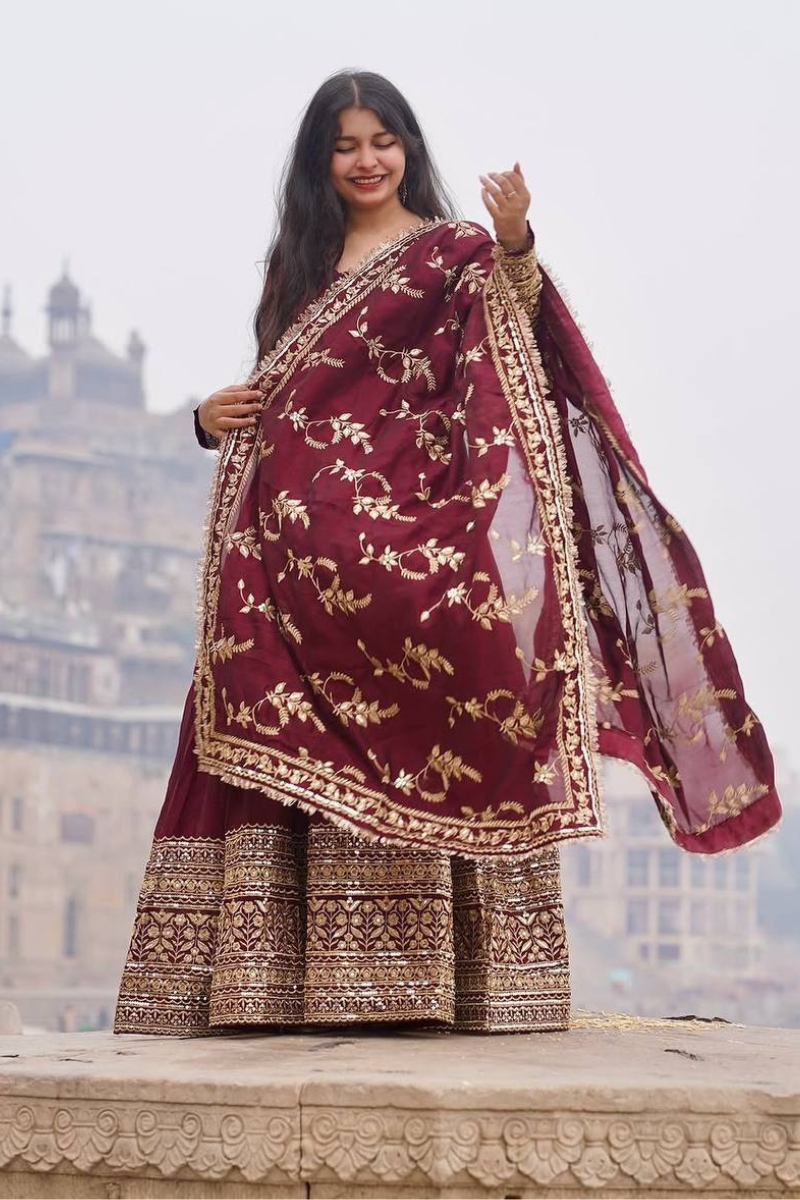 Faux Maroon Three-piece suit set with a Georgette gown, dupatta, and pants