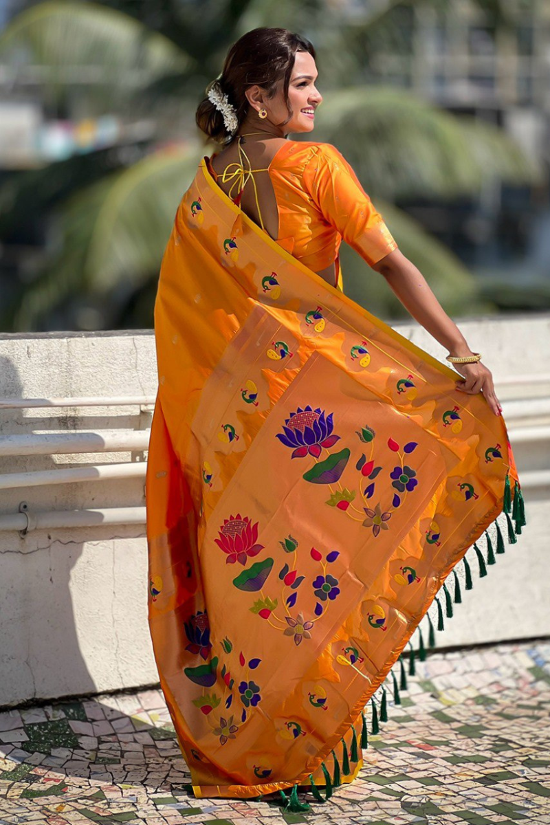 Sarees in orange Paithani with zari patterns throughout